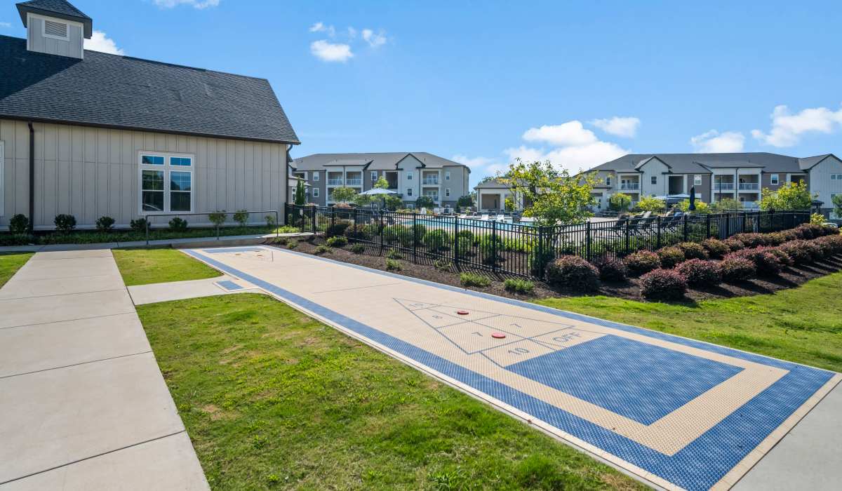 Outdoor lounge chairs and firepit near the swimming pool at The Standard at Pinestone in Travelers Rest, South Carolina