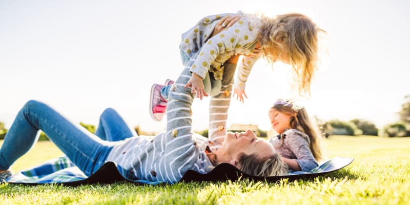 A mother playing with her children at a park near Harborview in Oceanside, California