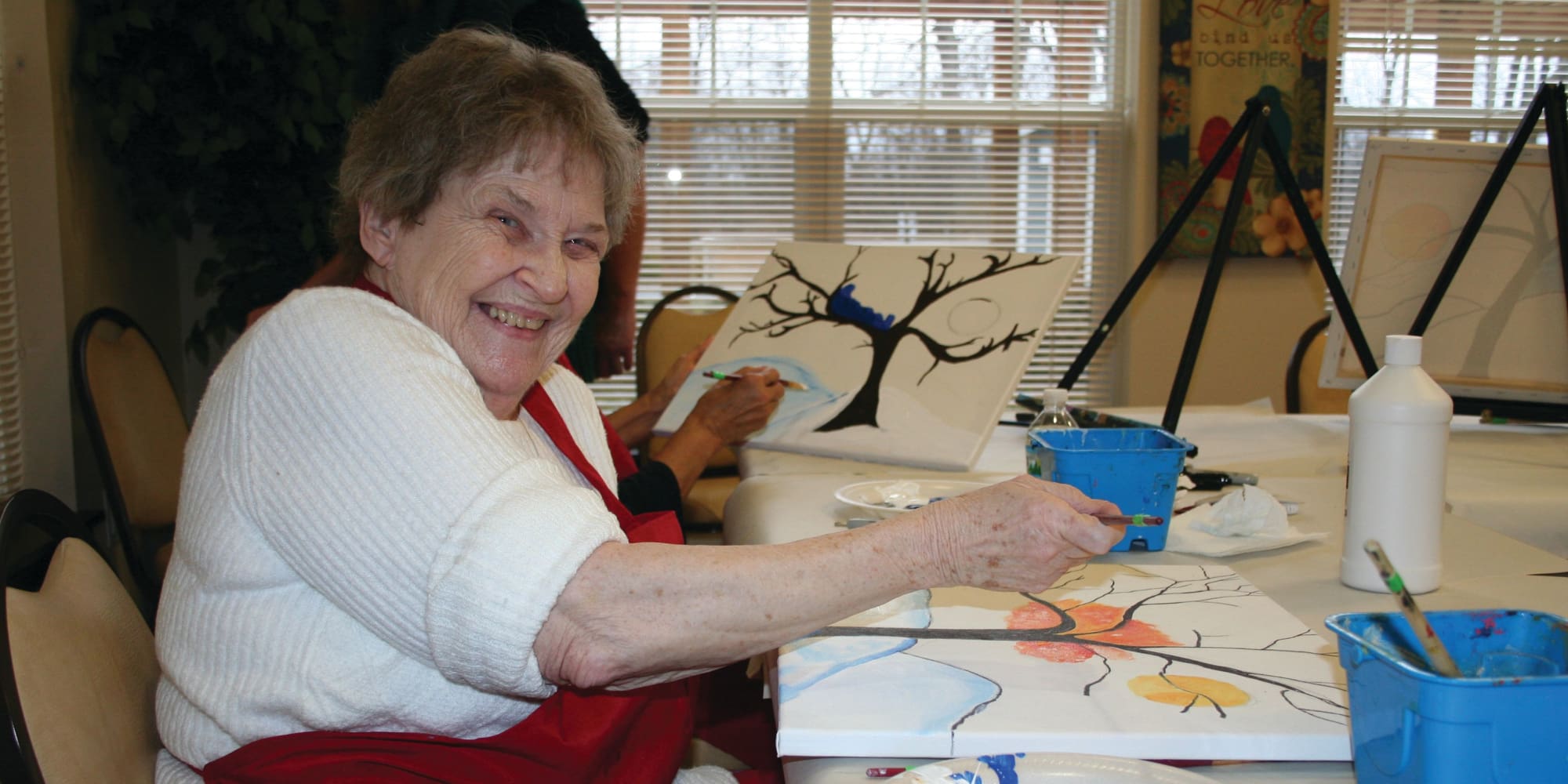 A resident painting at Mulberry Gardens Memory Care in Munroe Falls, Ohio