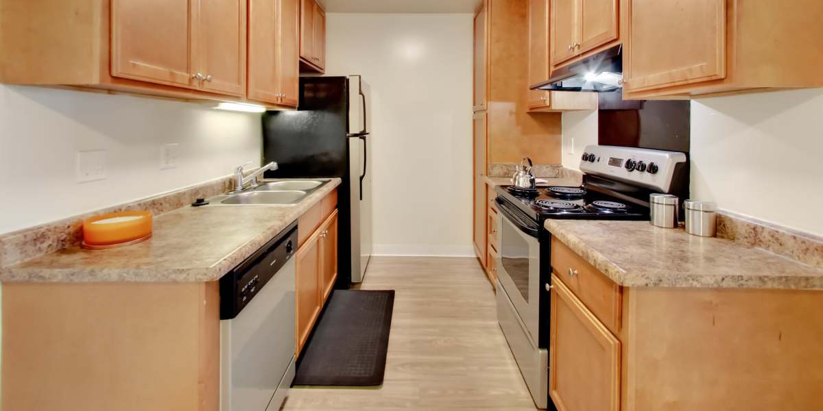 Kitchen with wooden cabinetry at Lakeside Village in San Leandro, California