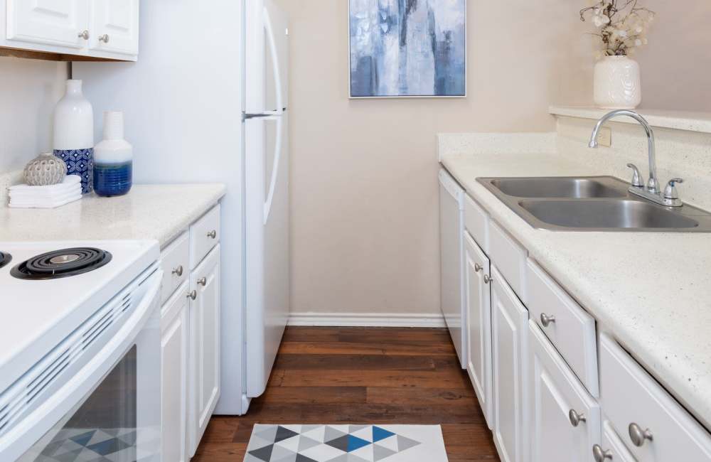Modern kitchen with sleek cabinetry and a cozy atmosphere at Charter Oak in Euless, Texas.