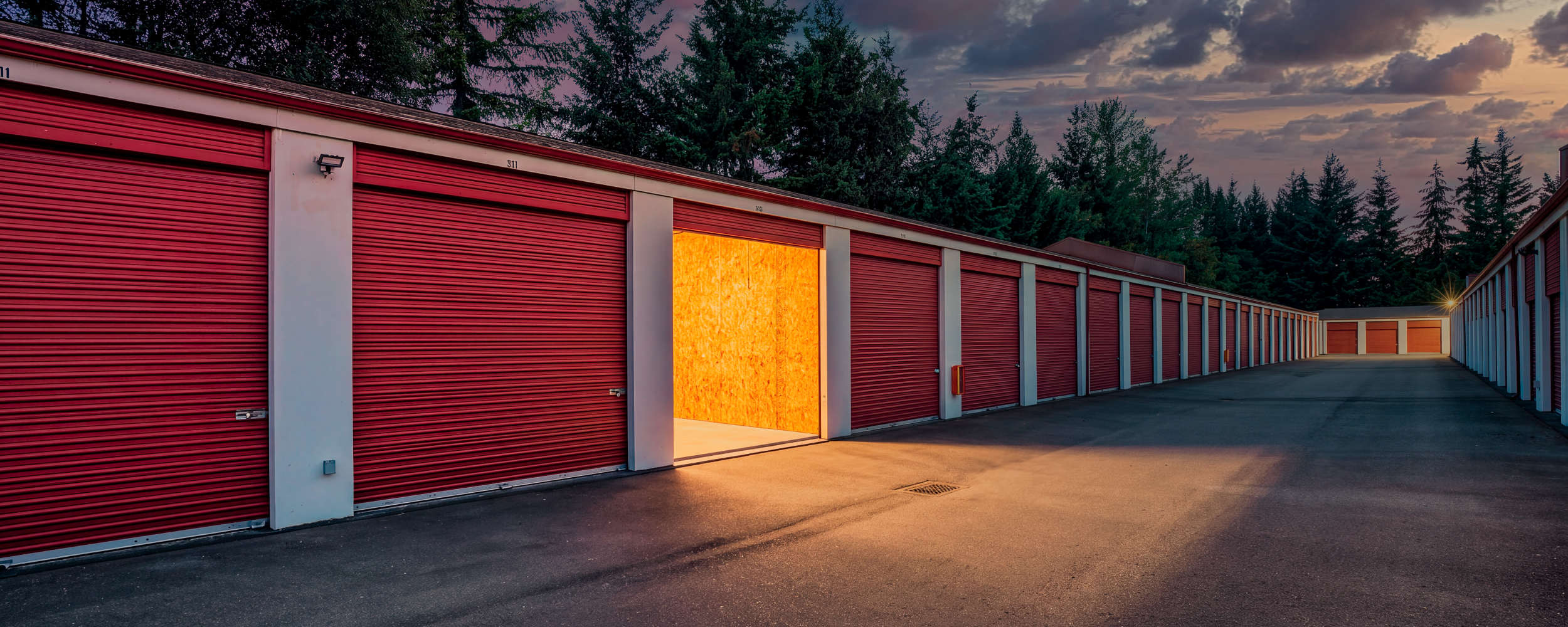 Twilight shot of lit up exterior drive up unit Centennial Storage in Bonney Lake, Washington