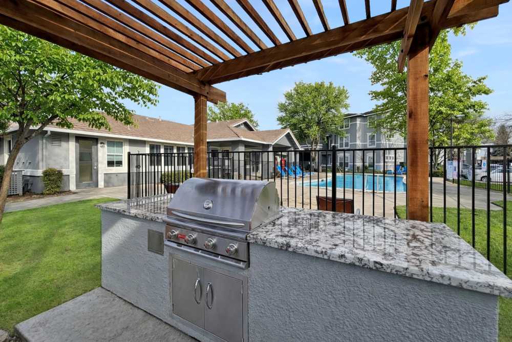 Grilling stations near the swimming pool at Natomas Park Apartments in Sacramento, California