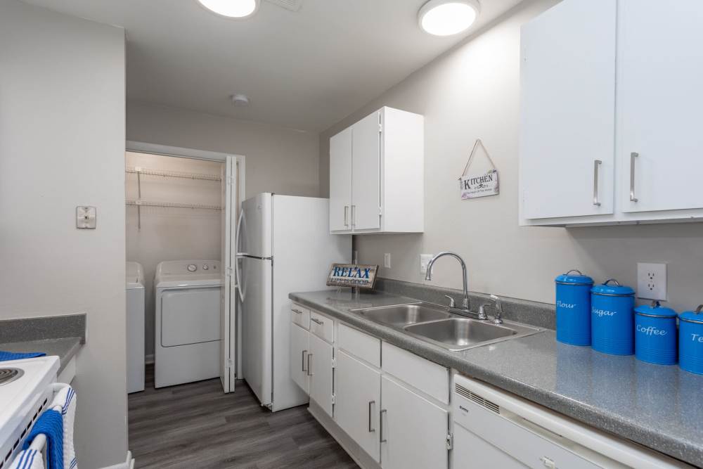 Kitchen with access to washer and dryer area at Landmark Flats in Fayetteville, North Carolina