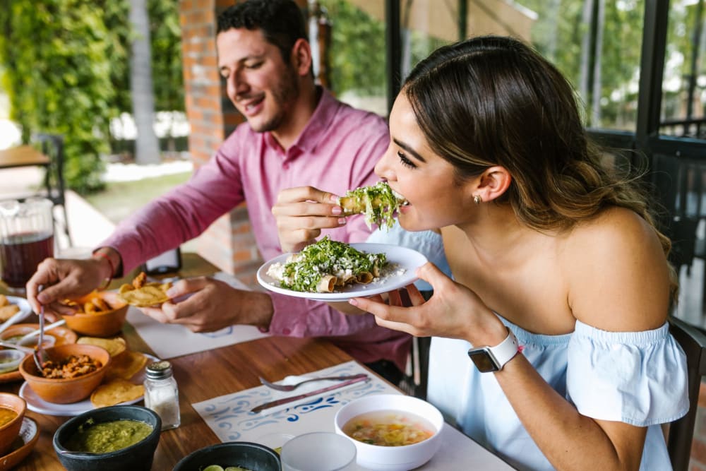 Resident couple eating lunch at a restaurant near Lockhart Apartment Homes in Mesquite, Texas 