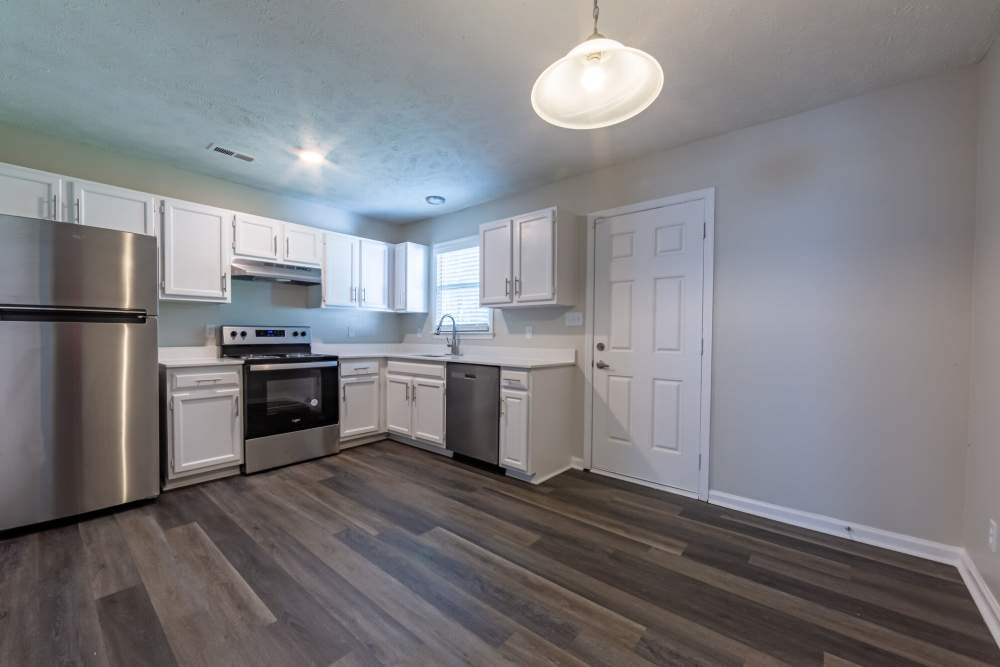 Kitchen with wooden cabinets at Cape Fear Townhomes in Fayetteville, North Carolina