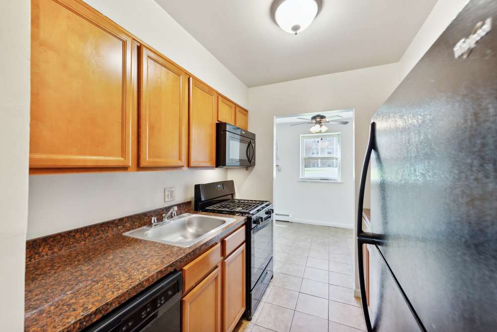 Another view of kitchen with stainless-steel sink, microwave and refrigerator at Ridgeview Apartment Homes in Reading,Pennsylvania