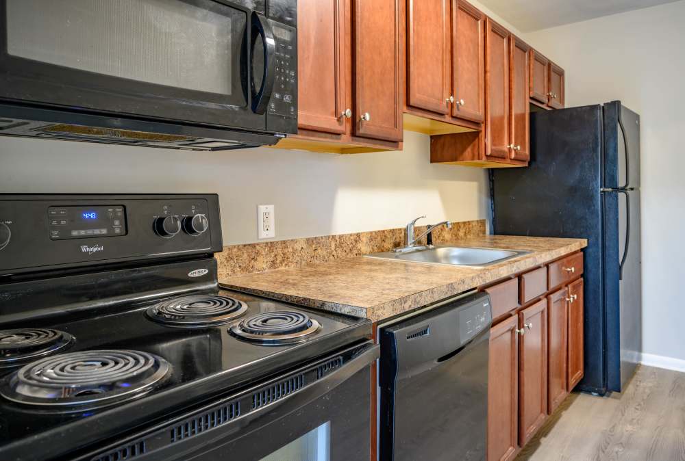 Kitchen with refrigerator at Country Manor Apartment Homes in Webster. NY