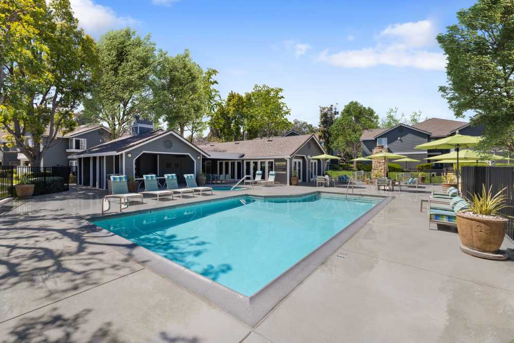 Pool with loungers and outdoor firepit at Village Oaks in Chino Hills, California