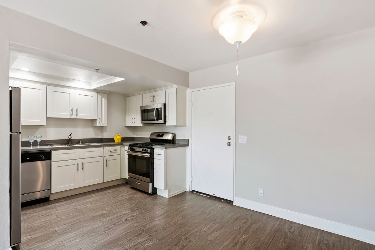 Kitchen with wood-style flooring at Kingsley Drive Apartments, Los Angeles, California