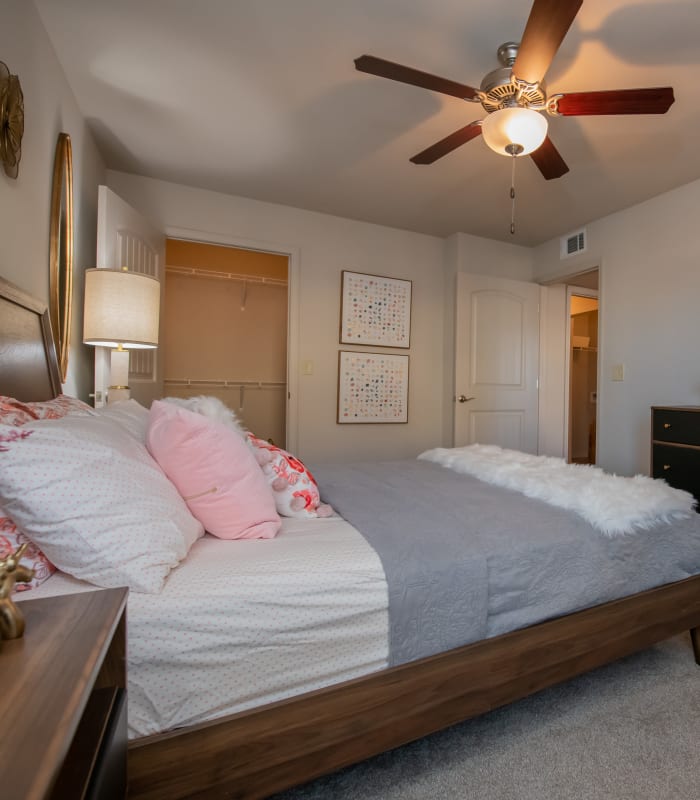 Chic bedroom with ceiling fan at Portico at Friars Creek Apartments in Temple, Texas