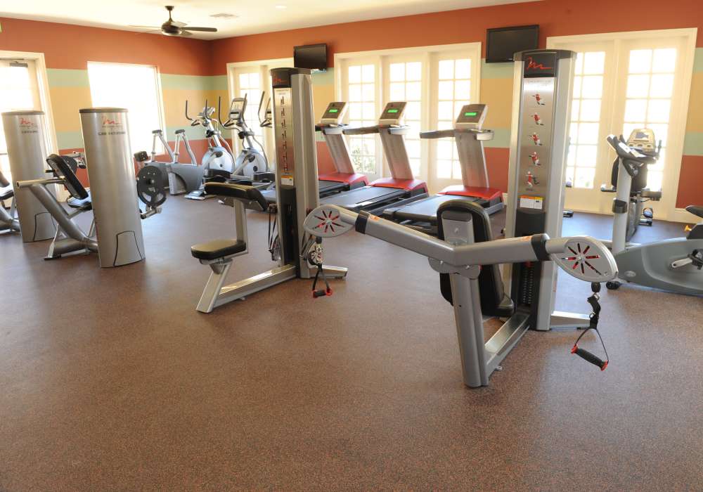 Bright and inviting fitness center featuring state-of-the-art equipment and ample natural light, perfect for your health and wellness journey at Cresta Bella in San Diego, California