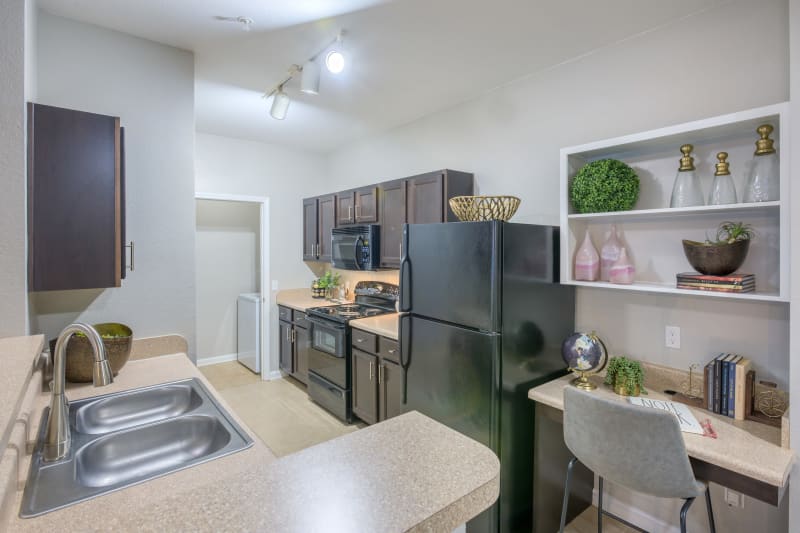 Modern kitchen with beautiful wood cabinets and ample counter space at The Vive in Kannapolis, North Carolina