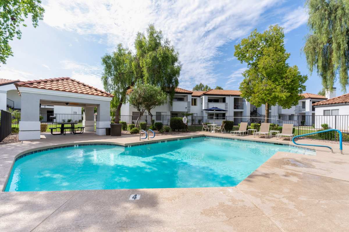 Swimming pool with patio and lounge chairs