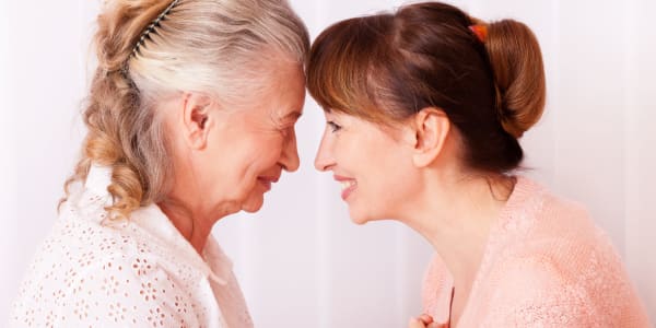 Resident and daughter touching foreheads at Montello Care Center in Montello, Wisconsin