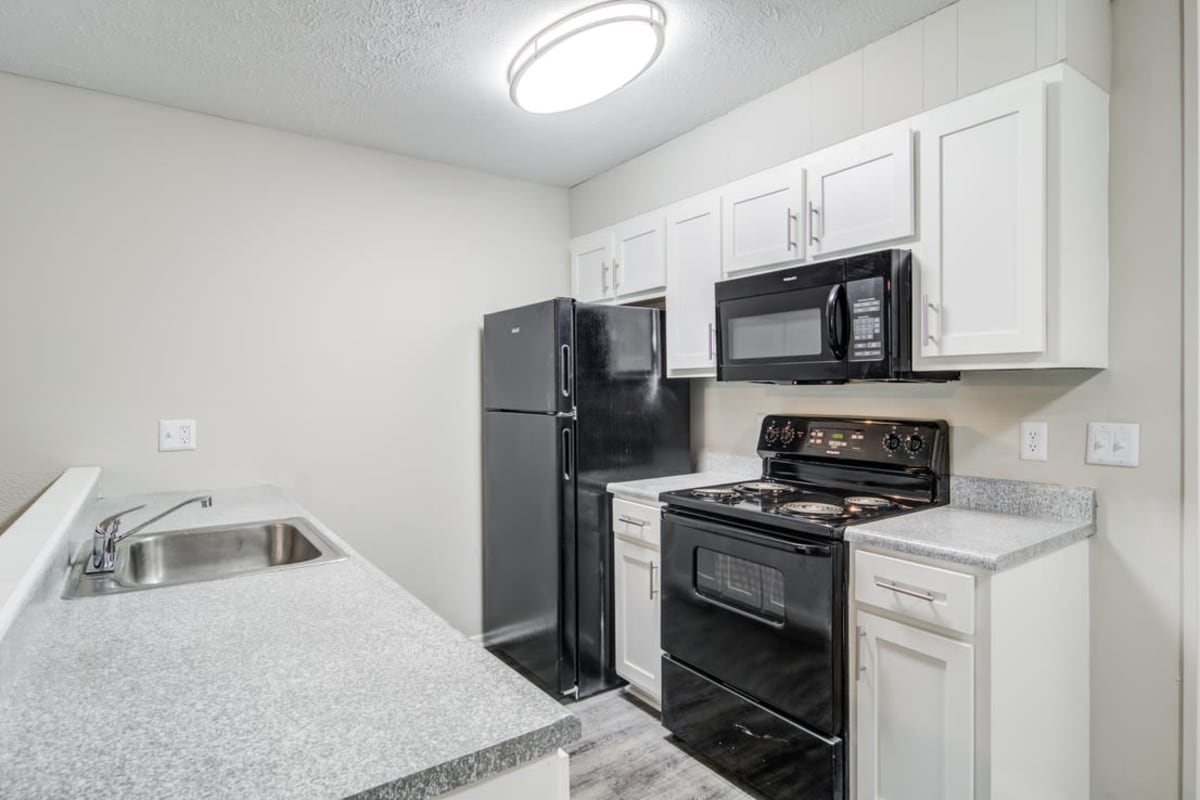 Kitchen with black appliances at Element at 3900 in Macon, Georgia