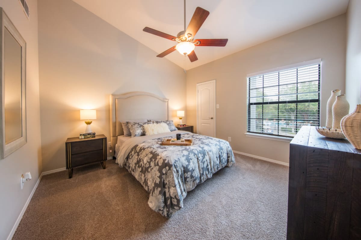 Bright bedroom with carpet flooring at Marquis at Treetops in Austin, Texas
