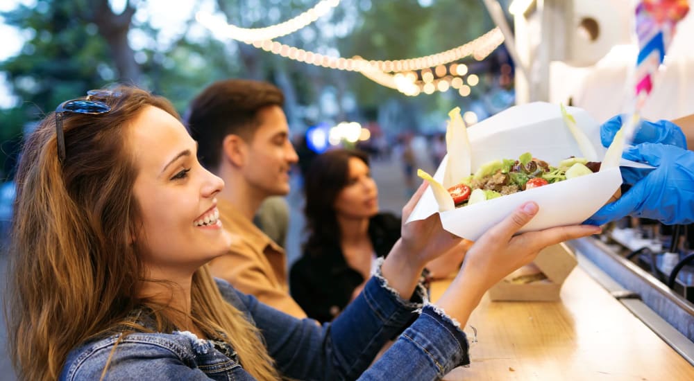 Residents grab a bite to eat at a food truck near Archer at Brookhill in Charlottesville, Virginia