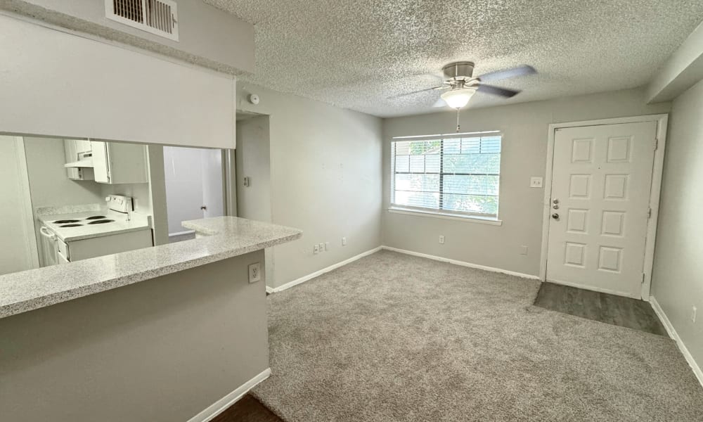 Living room with carpet flooring at Santa Fe Apartments in Dallas, Texas