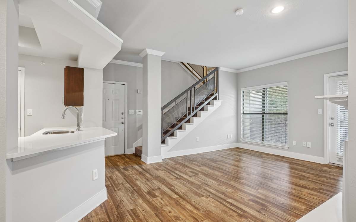 View of kitchen with wood flooring at Carrara at Cole in Dallas, Texas 