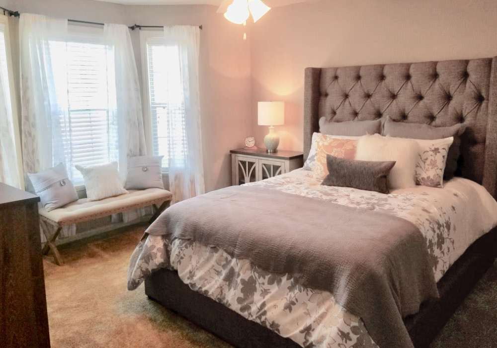 Spacious bedroom with ceiling fan and large window at The Reserve at Kanapaha in Gainesville, Florida