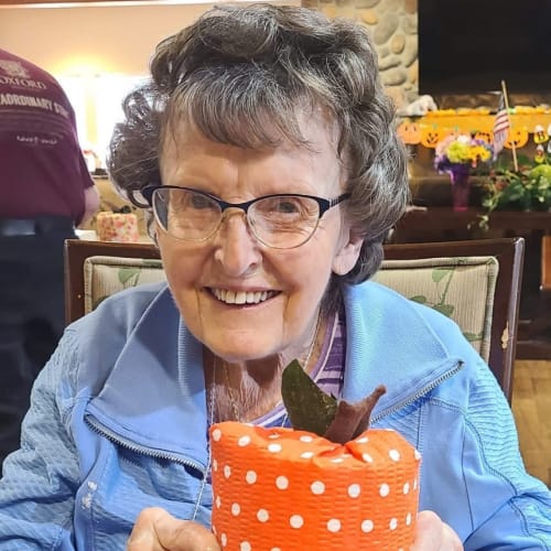Resident holding a wrapped gift at The Oxford Grand Assisted Living & Memory Care in Wichita, Kansas