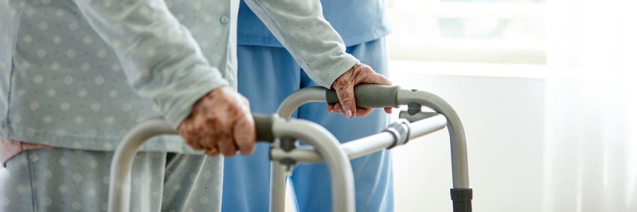 Resident receiving help walking at East Troy Manor in East Troy, Wisconsin