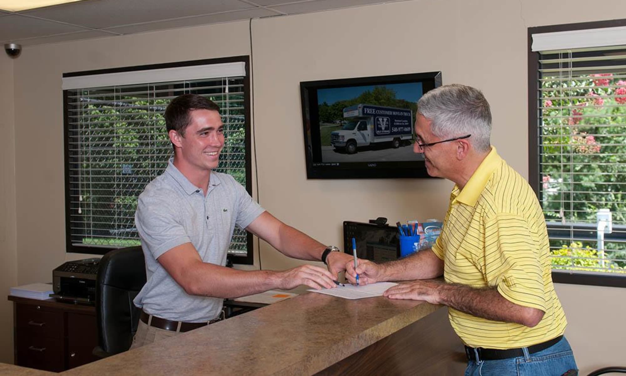 A Virginia Varsity Storage employee helps a customer in Roanoke, Virginia