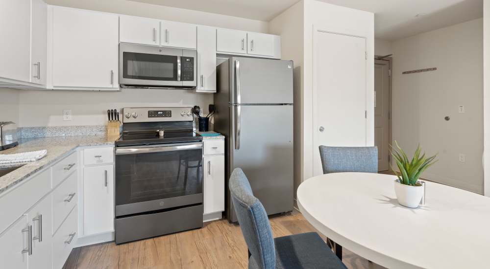 Kitchen with stainless-steel appliances at WaterWalk Kansas City - Overland Park in Overland Park, Kansas