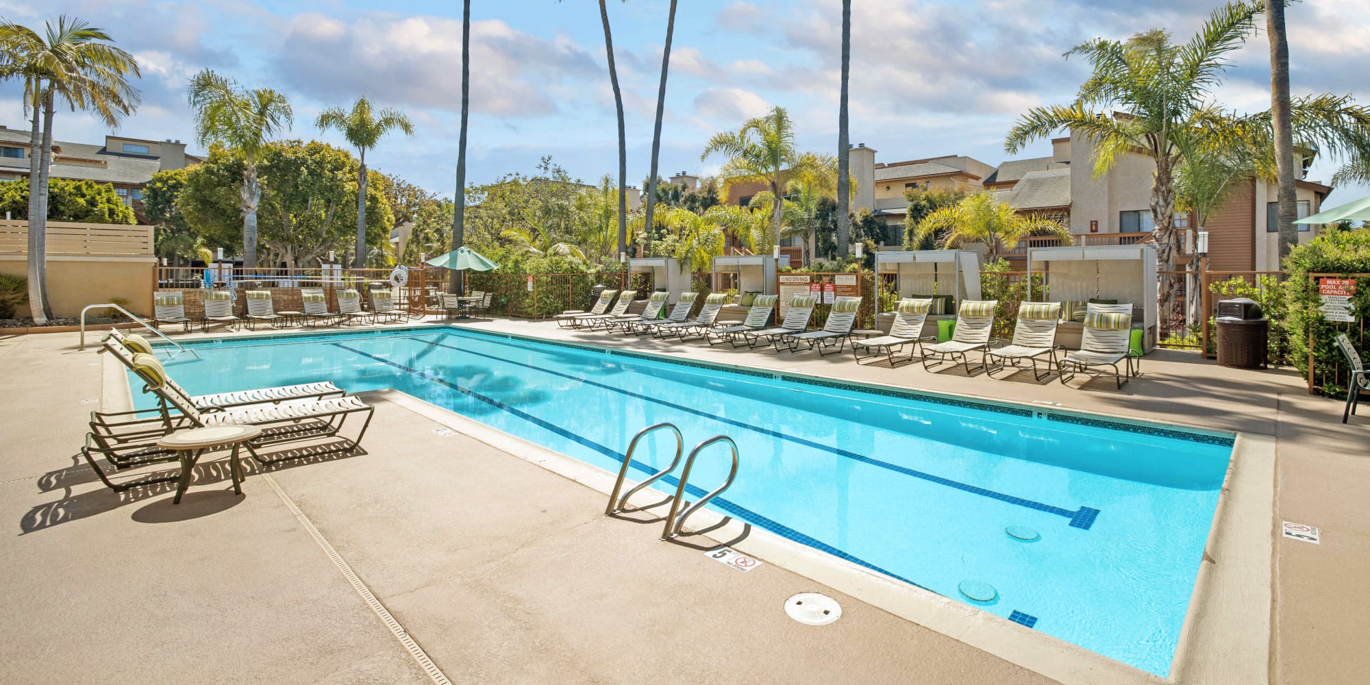 Swimming pool with lounge chairs at Allina La Jolla in San Diego, California