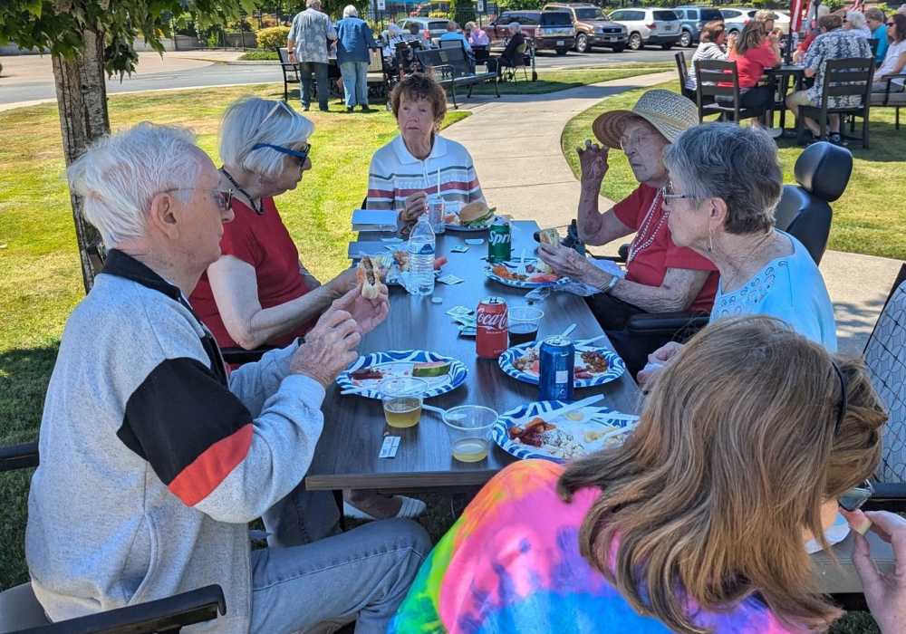 Residents eating lunch outside at Merrill Gardens at Tacoma in Tacoma, Washington