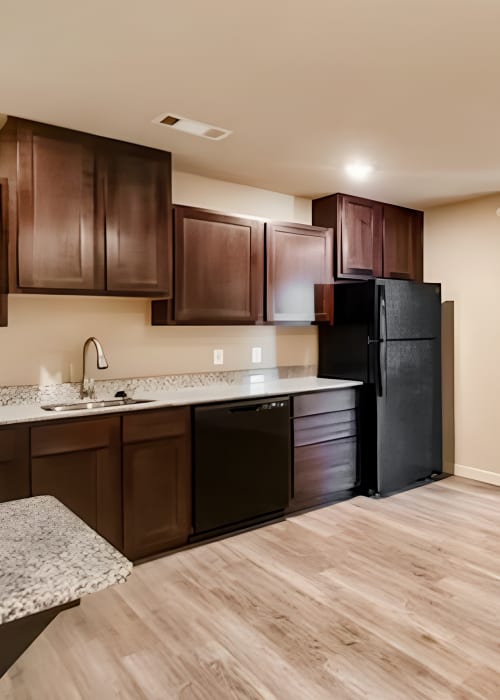 Kitchen with black appliances at Atlas at Cabot in Cabot, Arkansas
