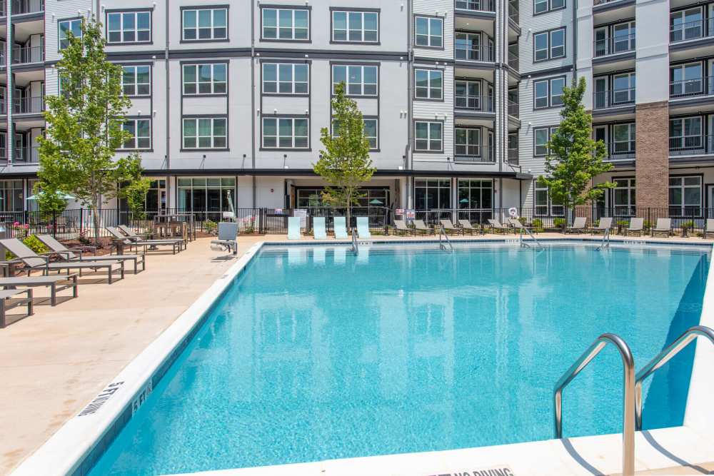 Swimming pool with lounge chairs at District at 54 in Raleigh,North Carolina