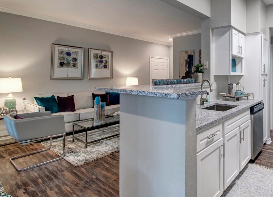 Comfortably decorated living area in the open-concept floor plan of a model home at The Lodge at River Park in Fort Worth, Texas