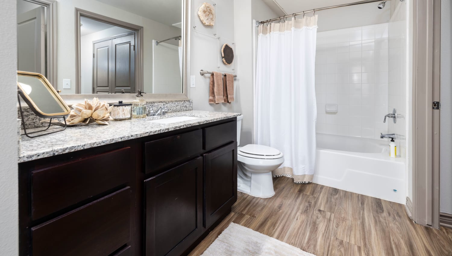 Large vanity mirror and granite countertop in a model home's bathroom at Anatole on Briarwood in Midland, Texas