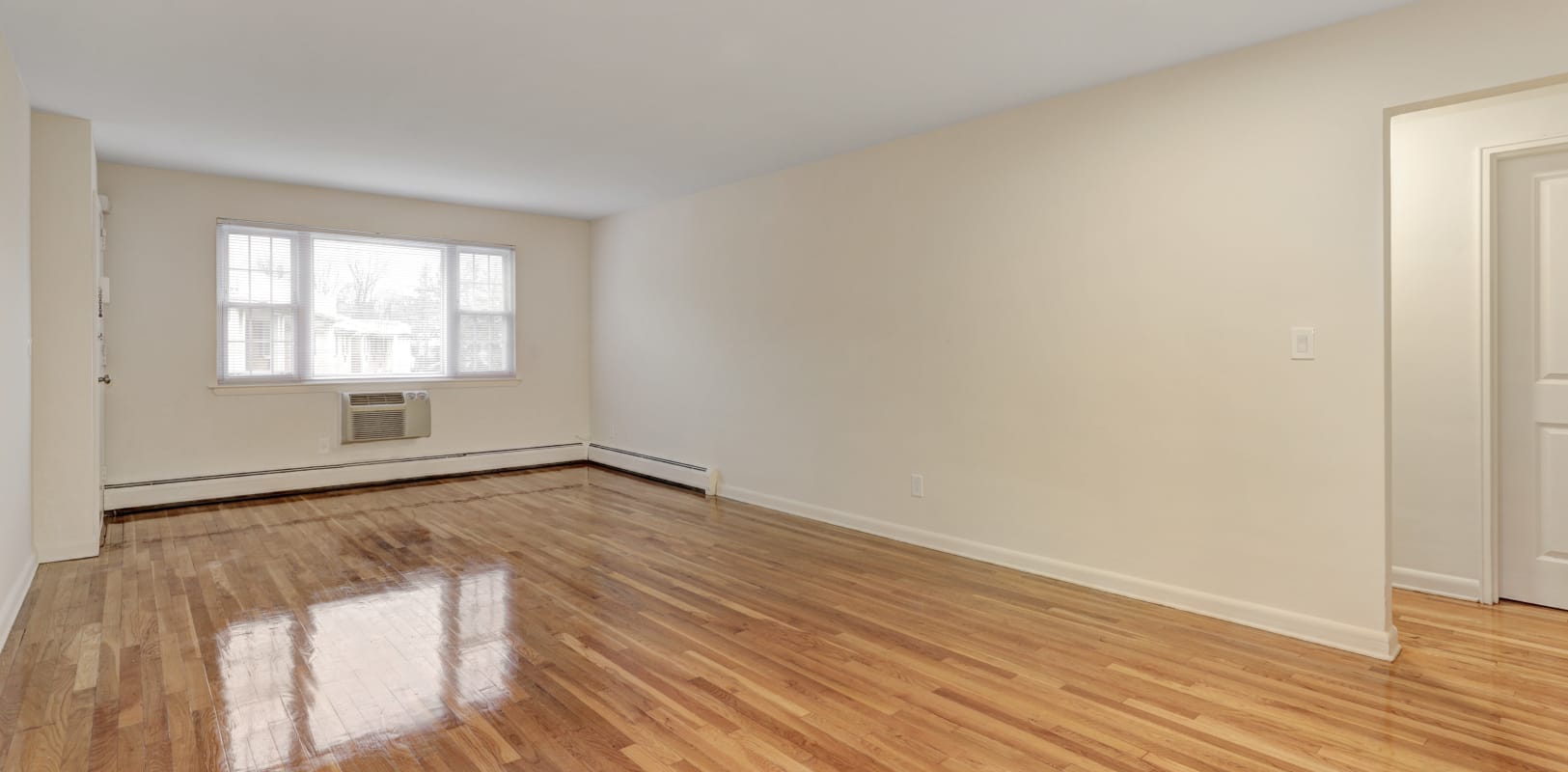 Hardwood floors in living room of a spacious apartment at Rosedale Manor in Madison, New Jersey