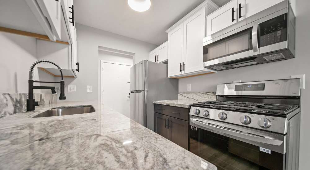 Well-equipped kitchen with granite countertops at Morada in Crystal, Minnesota
