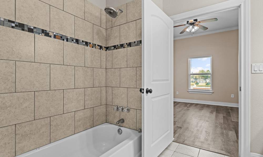 Bathroom with tub at The Arbors of Mineola in Mineola. TX