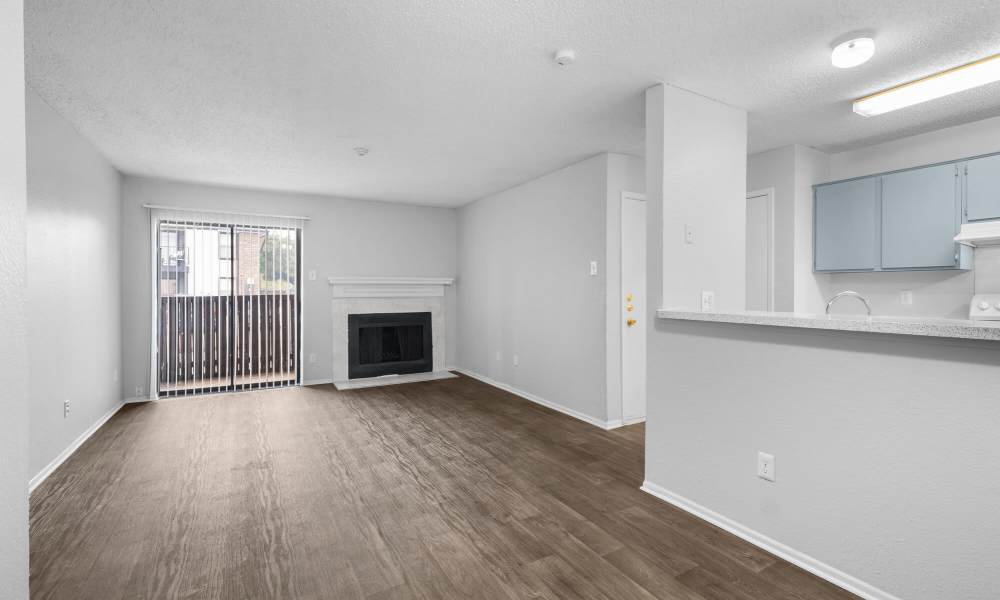 Unfurnished Living room with wood style flooring at Pine Oaks Apartments in Mesquite, Texas
