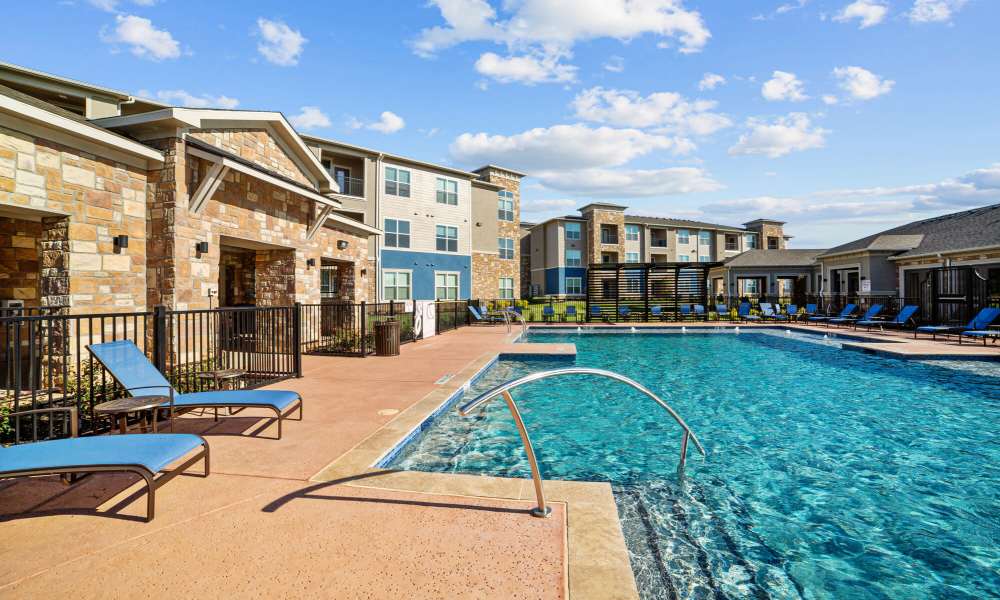 Charming pool with lounge beds at Brook Hollow in Wichita Falls, Texas