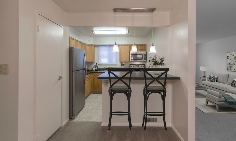 Kitchen with breakfast bar to serve and eat on at Penn Crest Apartments in Allentown, Pennsylvania