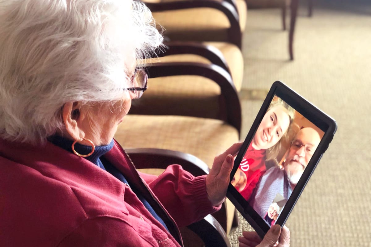 A resident using a tablet at Oxford Glen Memory Care at Sachse in Sachse, Texas