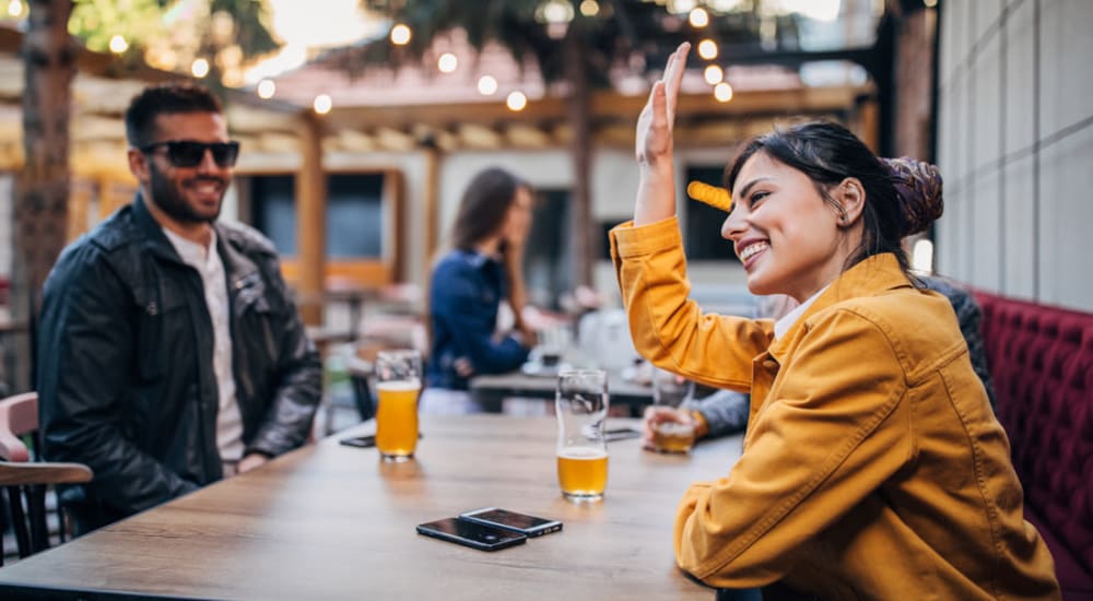 Resident friends having beers together, talking and enjoying each other's company at a restaurant near Sorrento in Stockton, California