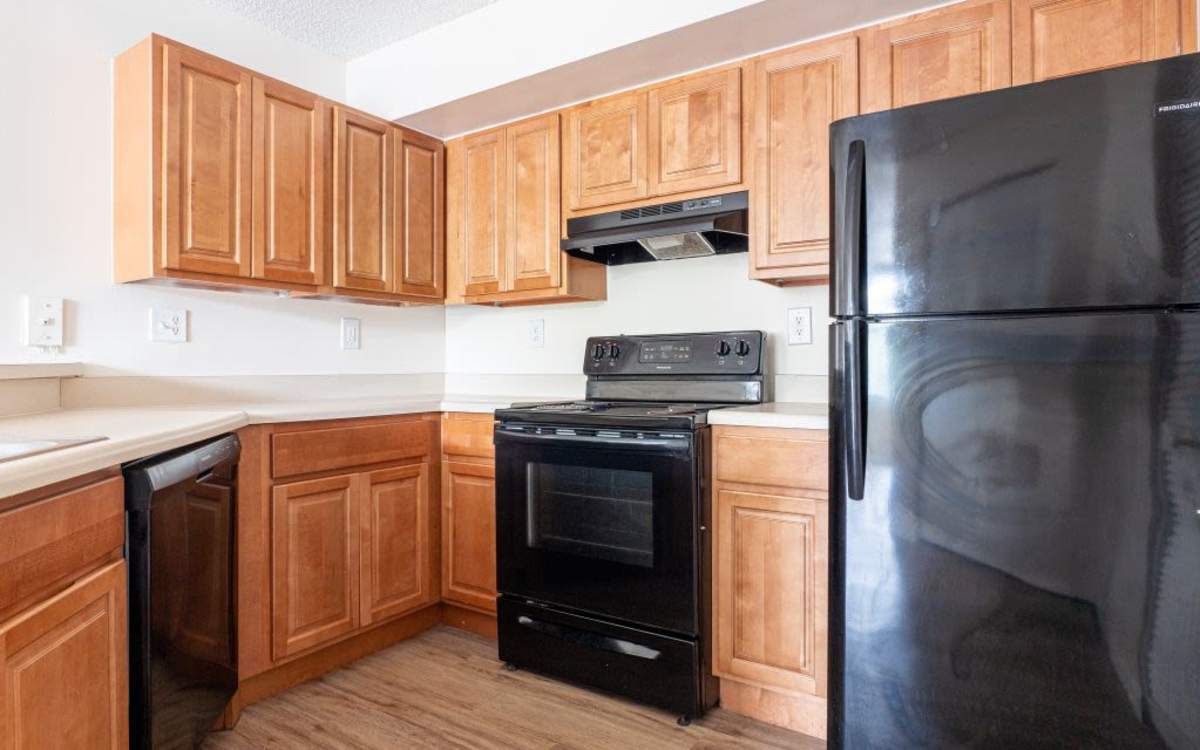 Modern kitchen with wooden cabinets at Logan Heights in Sanford, Florida