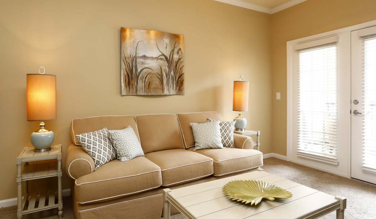 Warm-toned living room at Palisades of Jacksonville in Jacksonville,North Carolina
