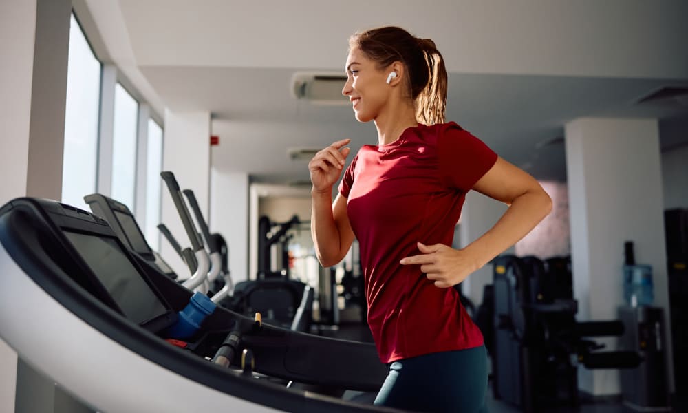 Woman running on treadmill at Avonlea Tributary in Lithia Springs, Georgia