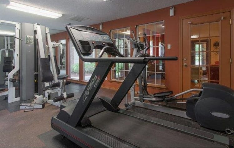 Fitness center for residents with individual workout stations at The Regent in Dallas, Texas