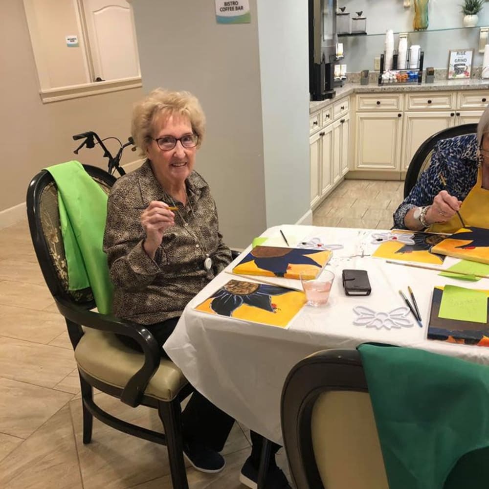 A resident making a painting at Inspired Living Sugar Land in Sugar Land, Texas.