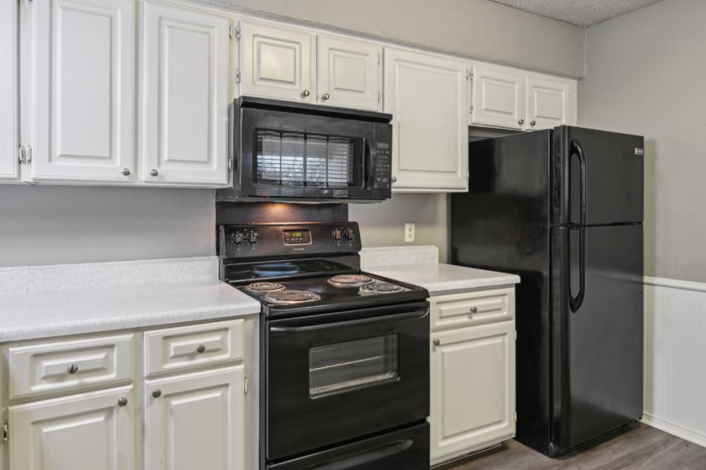White countertops and modern appliances at Courts of Bedford in Bedford, Texas