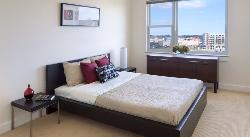 Model bedroom with wall art at Metro Green Residences in Stamford, Connecticut